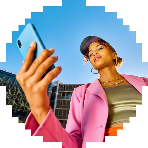 Woman in a pink jacket looking at her phone